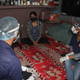 Asha volunteers enquire about the health of a recovered covid patient.